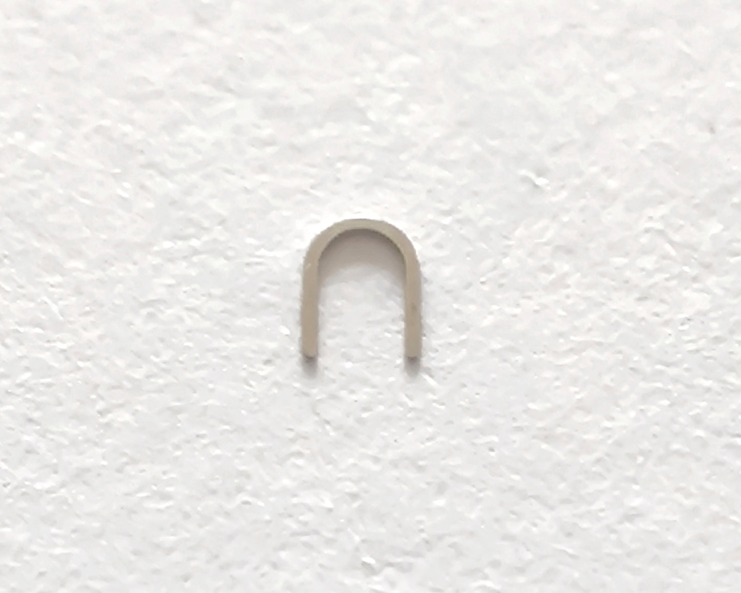 Omega 100-1345 Incabloc bolt upper original watch movement part close-up front view